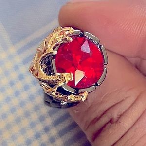 Dragon wrapped around a red stone grey ring with scales along the sides